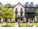 Attractive townhomes with a combination of light brick and dark siding, featuring small, inviting balconies at 135 Climbing Ivy Cir, Fayetteville, GA 30214