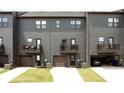 Back view of townhomes with garages and small balconies, showcasing the functional design at 135 Climbing Ivy Cir, Fayetteville, GA 30214