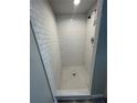 Bathroom features a newly renovated shower with subway tile and mosaic-tiled floor at 1440 Kenilworth Sw Dr, Atlanta, GA 30310