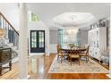 Elegant dining room with hardwood floors, designer chandelier, and an abundance of natural light at 220 Foxley Way, Roswell, GA 30075