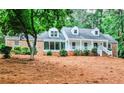 Charming brick home featuring manicured landscaping and inviting front porch; perfect blend of classic style and modern comfort at 2244 Deer Ridge Dr, Tucker, GA 30087