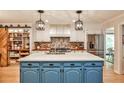 Modern kitchen with a large center island, custom cabinetry, stainless steel appliances, and stylish lighting at 2244 Deer Ridge Dr, Tucker, GA 30087