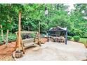 Outdoor patio features a swing and pergola, perfect for relaxing and entertaining in this serene backyard space at 2244 Deer Ridge Dr, Tucker, GA 30087
