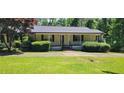 Single-story home with black shutters, landscaping, and a front porch at 294 A Donald Rd, Canton, GA 30114