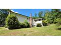 Exterior of house featuring chimney, screened in porch and green yard at 294 A Donald Rd, Canton, GA 30114