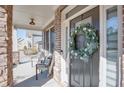 Charming front door with a wreath, complemented by the welcoming front porch and decorative stone pillars at 5015 Montes Ln, Cumming, GA 30040