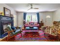 Bright living room with hardwood floors, fireplace, and large windows with blue curtains at 588 Oakdale Ne Rd, Atlanta, GA 30307