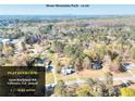 Aerial view of the property with mature trees and proximity to Stone Mountain Park at 6316 Rockland Rd, Lithonia, GA 30038