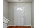 Bright entryway with wood flooring and a white front door with half-round window at 1436 Arbor Place Dr, Morrow, GA 30260