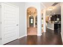 Inviting foyer with hardwood floors, arched doorways, and views into the dining room, living area, and kitchen at 2753 Trebek Ct, Mcdonough, GA 30253