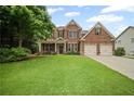 Charming two-story brick home with a lush green lawn and two-car garage at 2955 Pleasant Valley Trl, Cumming, GA 30028