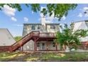 Backyard view featuring a spacious deck and a brick-paved patio at 1224 Everwood Sw Dr, Marietta, GA 30008