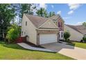 Side view of a two-story home showing the attached garage and well-maintained lawn at 1224 Everwood Sw Dr, Marietta, GA 30008