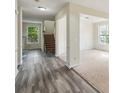 The foyer features wood-look flooring and access to the stairs and living room at 1224 Everwood Sw Dr, Marietta, GA 30008