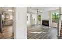 Bright living room with fireplace, ceiling fan, and doorway to the kitchen at 1224 Everwood Sw Dr, Marietta, GA 30008