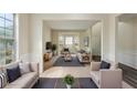 Spacious living room with large windows, comfortable seating, and neutral colors at 1224 Everwood Sw Dr, Marietta, GA 30008