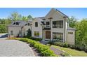 Beautiful exterior view of the stunning white home with a circular driveway at 1285 Stuart Rdg, Johns Creek, GA 30022