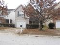 Charming two-story home featuring a one-car garage and a cozy front porch, located on a street at 2019 Briar Creek Ne Ct, Conyers, GA 30012