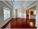 Elegant dining room featuring hardwood floors, large window, decorative trim, open to the kitchen and living area at 4060 San Marco Way, Douglasville, GA 30135