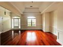Bright living room with hardwood floors, large windows, and elegant trim work adding to the room's appeal at 4060 San Marco Way, Douglasville, GA 30135