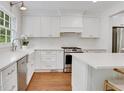 Modern kitchen featuring white cabinetry, stainless steel appliances and a farm sink at 770 Wellesley Nw Dr, Atlanta, GA 30305