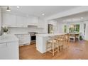 Bright, airy kitchen with white cabinets, stainless steel appliances, island with seating, and breakfast area at 770 Wellesley Nw Dr, Atlanta, GA 30305