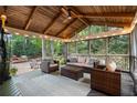 Inviting screened porch with comfortable seating, wood ceiling, and views of the outdoor space at 1435 Withmere Ln, Atlanta, GA 30338