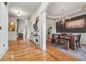 Open dining room with wood floors, modern chandelier, and wainscoting at 3282 Green Farm Trl, Dacula, GA 30019