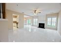 Open living room featuring tile floors, fireplace, and seamless transition to kitchen and backyard at 3601 Gainesway Trce, Duluth, GA 30096