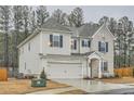Spacious home showcasing a two-car garage, brick accents and clean siding with complementary blue shutters at 3652 Silvery Way, Powder Springs, GA 30127