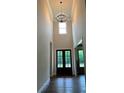 Stunning foyer featuring a soaring ceiling, elegant chandelier, and beautiful double front doors at 5907 Sw Bunting Ln, Atlanta, GA 30331