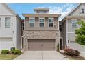 Inviting townhome with a two-car garage, brick and siding facade, and well-maintained front yard at 1227 Herty Dr, Marietta, GA 30062