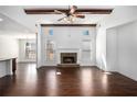 Bright living room with high ceilings, wood beams, stone fireplace, and hardwood floors at 448 Hanover Drive, Villa Rica, GA 30180