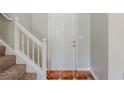 Clean entryway featuring a white front door, neutral walls, and tiled flooring at 4889 Hidden Creek Pl, Decatur, GA 30035