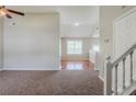 Inviting living room with neutral carpet, bright window, and an open floor plan at 4889 Hidden Creek Pl, Decatur, GA 30035