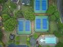 An aerial view of community tennis courts, playground, and a sparkling outdoor pool at 1425 Turtle Dove Ln, Lawrenceville, GA 30043