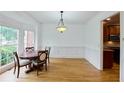 Dining room with natural light from the window, hardwood floors, and decorative moldings at 1425 Turtle Dove Ln, Lawrenceville, GA 30043