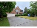 Beautiful two-story brick home with a well-manicured lawn and attached two-car garage at 1425 Turtle Dove Ln, Lawrenceville, GA 30043