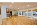 Spacious living room with hardwood floors, many windows, and access to the backyard patio at 1425 Turtle Dove Ln, Lawrenceville, GA 30043