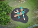 Aerial view of community playground featuring wood and green slides and climbing structures at 1425 Turtle Dove Ln, Lawrenceville, GA 30043