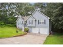 Attractive two-story home featuring a two-car garage and a well-maintained lawn with mature landscaping at 144 Boones Ridge Se Pkwy, Acworth, GA 30102
