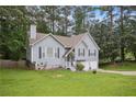 Inviting two-story home with well-kept lawn, mature trees, and a driveway leading to an attached two-car garage at 144 Boones Ridge Se Pkwy, Acworth, GA 30102