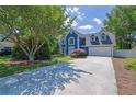 Two-story home featuring a spacious driveway and well-maintained lawn surrounded by mature trees at 1930 Huntcliff Dr, Lawrenceville, GA 30043