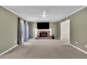 Living room with a fireplace, large windows, neutral color scheme and modern ceiling fan at 1930 Huntcliff Dr, Lawrenceville, GA 30043