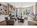 Comfortable living room with stone fireplace, built-in shelves, and large windows at 2172 Peach Se Ln, Smyrna, GA 30080