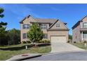 Two-story brick home with a well-manicured lawn, mature trees, and attached two-car garage at 3204 Ivy Farm Path, Buford, GA 30519