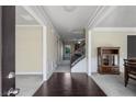Elegant foyer with hardwood floors, staircase, and decorative molding offering a view into other rooms at 3204 Ivy Farm Path, Buford, GA 30519