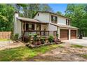Charming home features a welcoming front porch, two-car garage and well-kept lawn perfect for outdoor living at 466 Victoria Rd, Woodstock, GA 30189