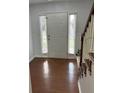 Open entryway features hardwood floors, staircase, sidelight windows, and a front door at 525 Dunagan Dr, Lawrenceville, GA 30045