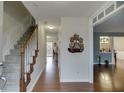Inviting entryway features hardwood floors, staircase, and an open view into the formal living room at 525 Dunagan Dr, Lawrenceville, GA 30045